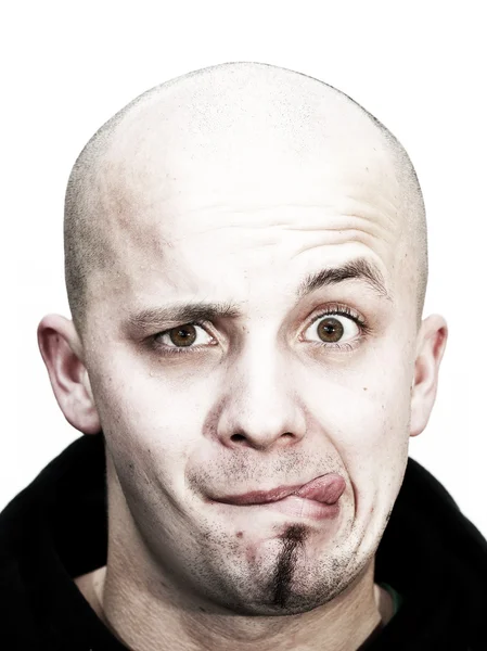 Young bald head teenager makes grimace with tongue outside and beard at his chin on white background — Stock Photo, Image