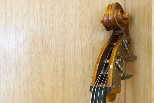 Hals eines Cellos lehnt an einer Holzwand — Stockfoto