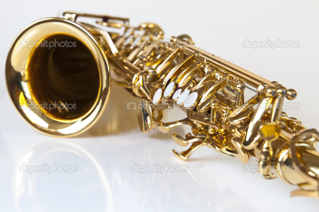 Golden concert saxophone on white background