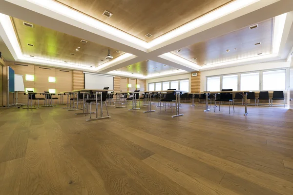 Lage weergave in houten klasse of conferentie kamer met bureaus — Stockfoto