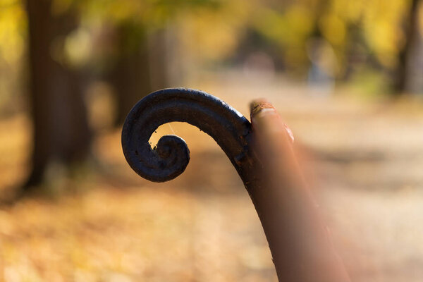 Detail of a metal element on a bench in an alley.