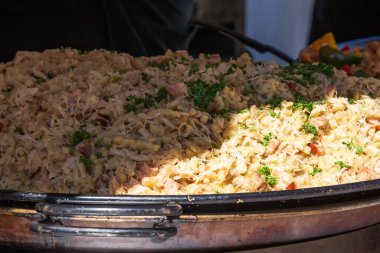 Gnocchi dough dumplings with cabbage in a pan at the market.