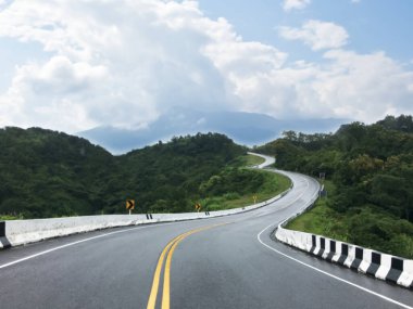 Blurred image of asphalt road which  looks like number 3, this road is in Nan, Thailand.