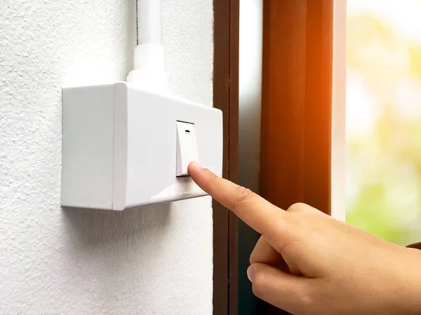 Female Home Owner Using Her Hand Turn Light Switch Panel — Stock Photo, Image