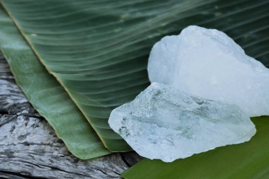 Alum on banana leaf with blurred background.