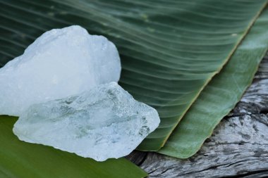 Alum on banana leaf with blurred background.