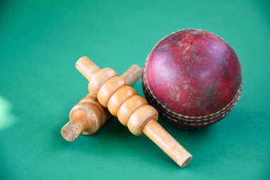 Old and used cricket ball on dark background used for cricket practice, soft focus.