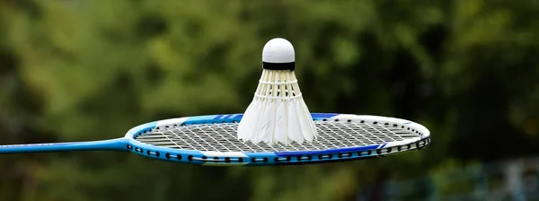White Cream Badminton Shuttlecock Blue Badminton Racket Outdoor Blurred Trees — Stockfoto