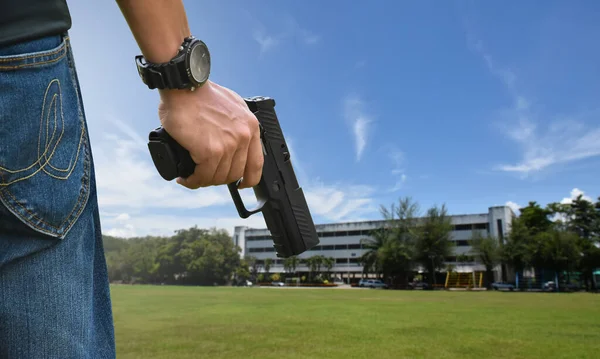 9mm automatic pistol holding in right hand of shooter, concept for security, robbery, gangster, bodyguard around the world. selective focus on pistol.