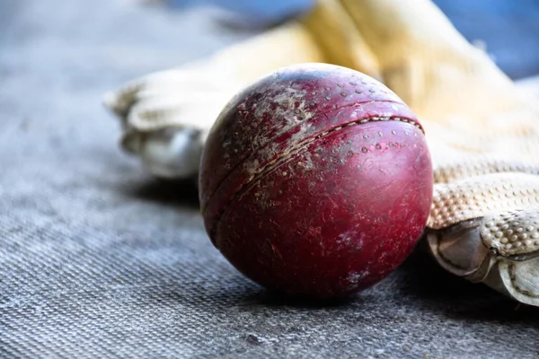 Cricket sport equipments on brick, bat, wicket, old leather ball, soft and selective focus.