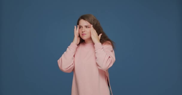 Frustrated girl suffering headache, massaging temples to relieve pain, severe migraine. Advertising of headache medicine — Stock Video