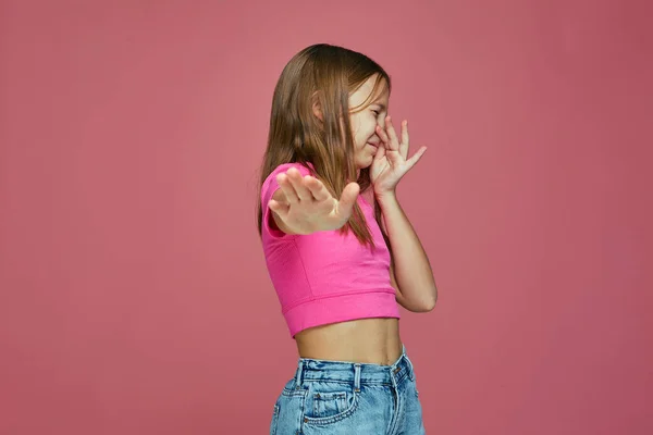 Bad smell. Child girl pinch nose showing stop gesture, feel disgust on pink studio background. Toxic hideous odor