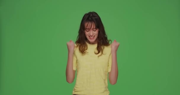 Overjoyed young girl make yes winner gesture, jumping, gesturing feel ecstatic triumph win on chromakey background — Stock Video