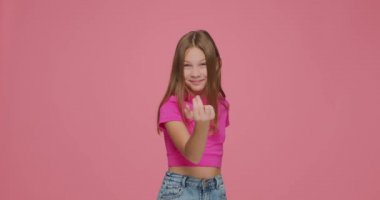 Yanıma gel. Komik çocuk kız yaklaşmak için davet ediyor, pembe stüdyo arka planında işaret ediyor.