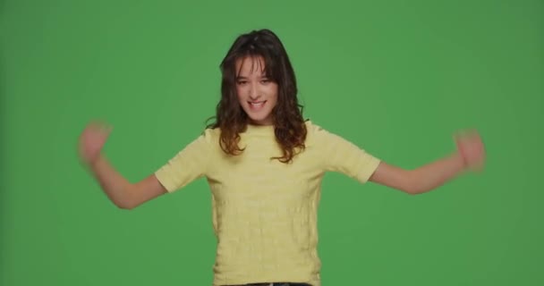 Cool funny young girl showing biceps, make muscles gesture, raising hands on chromakey background. Personal achievements — Stock Video