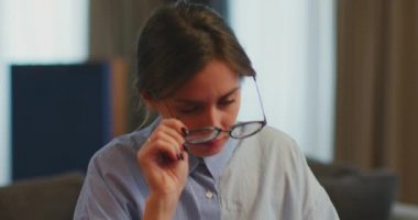Eye fatigue. Exhausted young girl take off glasses tired of long term computer work suffer eye strain, vision problem