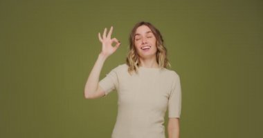 Smiling positive young woman show ok sign recommending service or product, making all right hands gesture