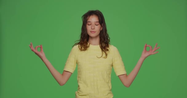 Calm young girl breathing making mudra om hands eyes closed, relive negative emotions or stress, breathe fresh air — Stockvideo