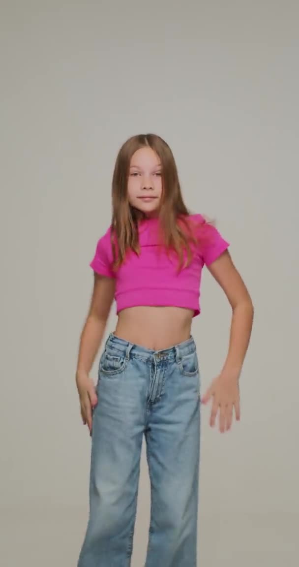 Vertical video of dancing modern energetic child girl cool moving recording dance moves for social network — Wideo stockowe