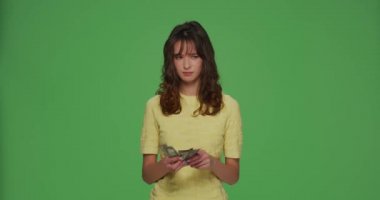 Financial problems. Frustrated young girl count cash need money for pay debt credit loan on chromakey green background