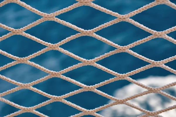 Knitted grid on boat banister — Stock Photo, Image