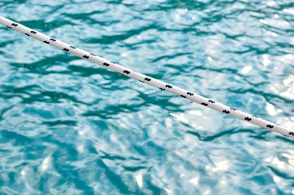 Marine rope over blue sea as background — Stock Photo, Image