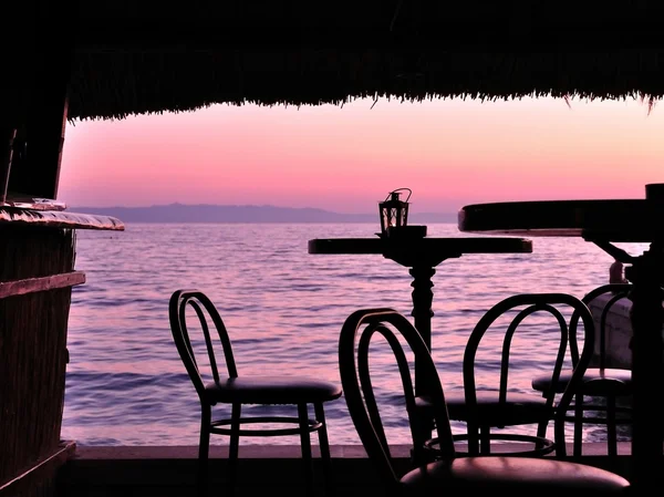 Silhouette di sedie a sdraio e tavoli nel bar tropicale — Foto Stock