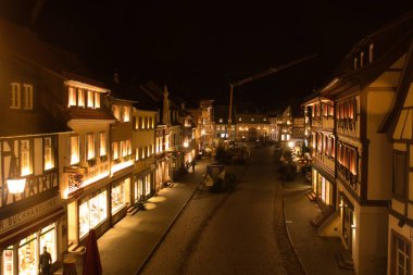Gengenbach, Germany - December 13, 2020: Looking down on a street from the clock tower at the edge of old town on a fall night in Gengenbach, Germany.