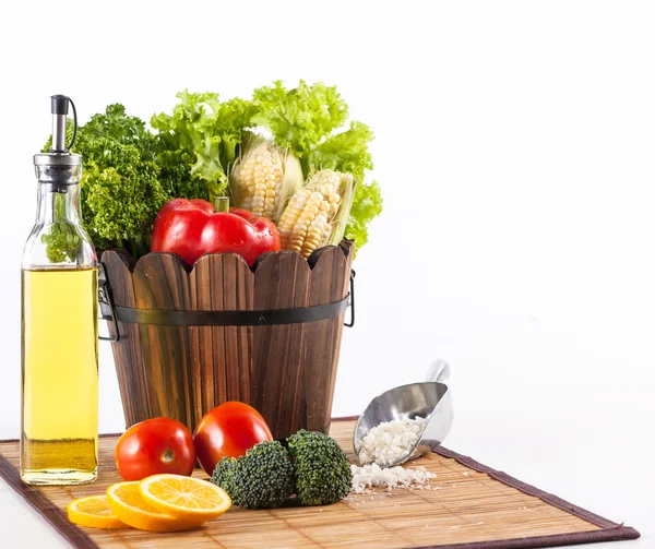 Fresh vegetables and other raw material set on a bamboo mat — Stock Photo, Image