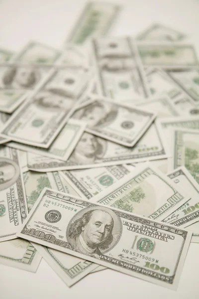 Dólares sobre un fondo blanco. — Foto de Stock