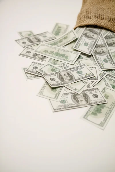 Деньги в сумке на белом фоне Лицензионные Стоковые Изображения