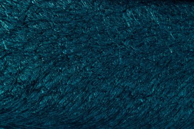 Petrol colored background with wavy textures of different shades of dark teal