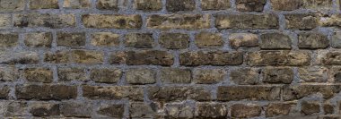 Wide weathered beige brown brick wall background