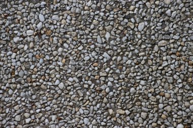 Arka plan için beton duvardaki küçük çakıl taşları