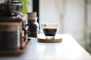 Beyaz masadaki ahşap tepside Espresso bardağı.