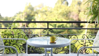 Beyaz cam masadaki sarı kahve fincanı.