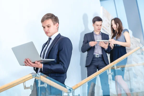 Businessman  holding a laptop on the stairs