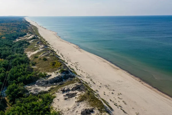 White sand beach. View to Baltic Sea Costline. Curonian Spit, Aerial view of the sea coast with waves. Travel and vacation concept