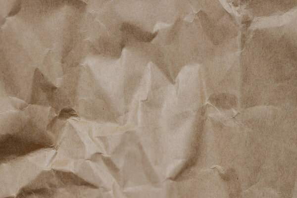 The texture of crumpled craft paper. Background. Close-up