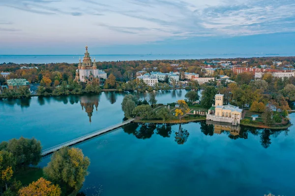 Panoramic aerial view of Holgin pond and the islands with pavilions in Peterhof,Peter and Paul Cathedral, wooden bridge to the island, reflected in the water, photo for a postcard — стоковое фото