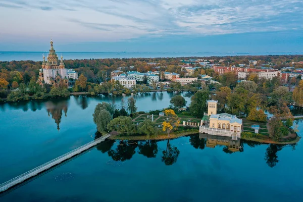 Panoramic aerial view of Holgin pond and the islands with pavilions in Peterhof,Peter and Paul Cathedral, wooden bridge to the island, reflected in the water, photo for a postcard — стоковое фото