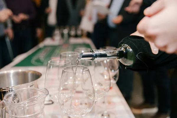 Waiter Pours White Wine Glass Background Green Table Wine Casino Fotografia De Stock