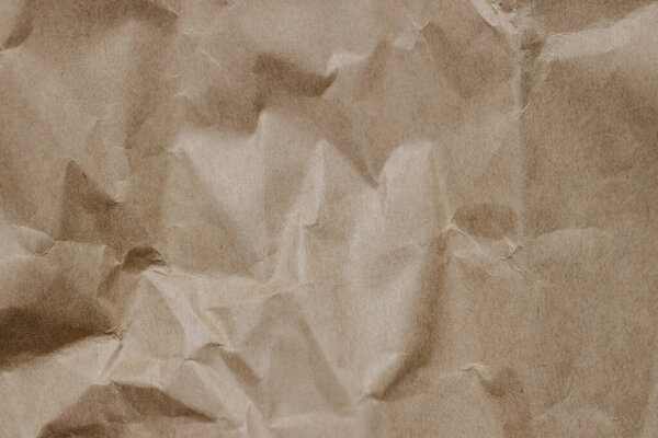 The texture of crumpled craft paper. Background. Close-up.