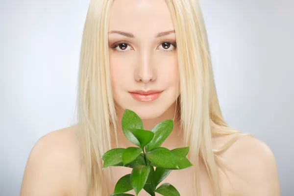 Girl with green sprout — Stock Photo, Image