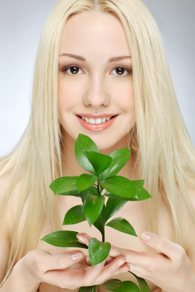 Girl with green sprout — Stock Photo, Image