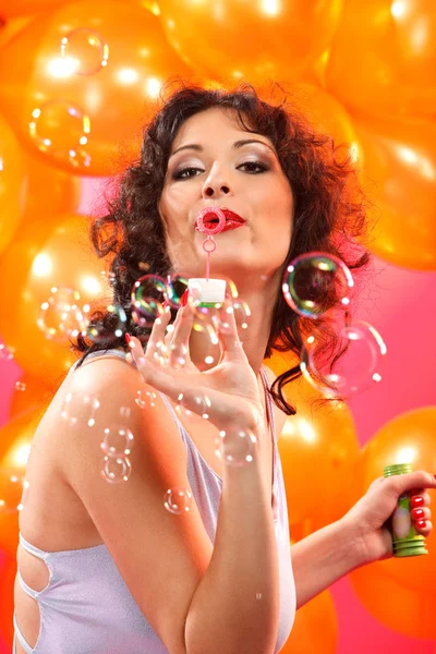Femme soufflant des bulles de savon — Photo