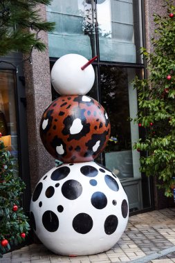 Farklı boylarda ve renkte üç toptan oluşan sıra dışı bir kardan adam. Sokakta bir oyuncak, uzun burunlu iri bir adam..