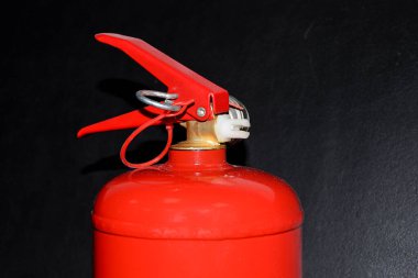 Siyah arka planda, kırmızı yangın söndürücüdeki basınç göstergesi silindirdeki basıncı gösteriyor. Yangını söndürmek için özel bir cihaz. Yangın söndürücüyü getir.!