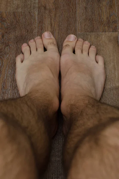 hairy male feet on the floor