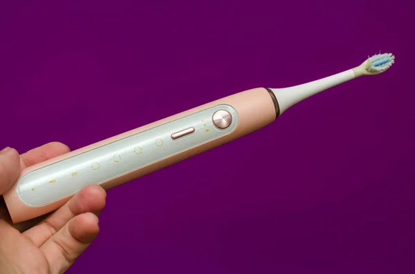 Pink Sonic Electric Toothbrush Hand Purple Background — Stock Photo, Image